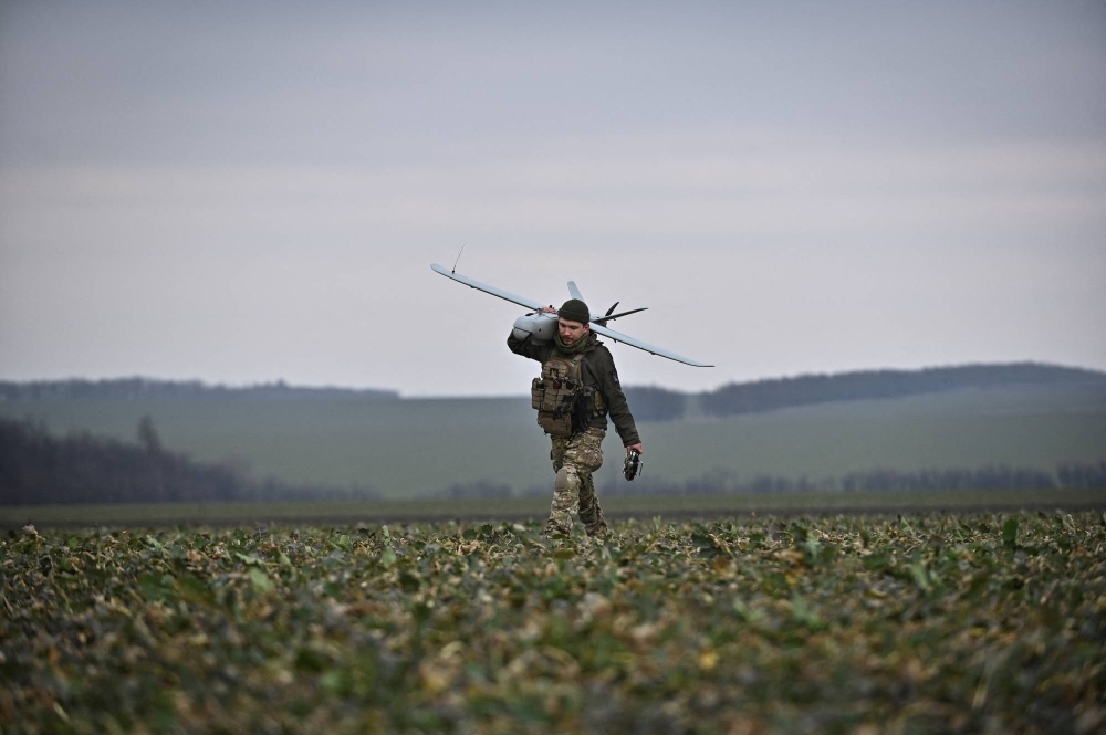 A Ukrainian serviceman carries a Leleka reconnaissance unmanned aerial vehicle (UAV) in Zaporizhzhia region, Ukraine, on Feb. 15