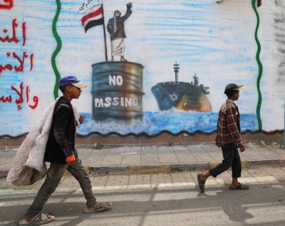Graffiti painted on a wall of the Saudi Arabian embassy in Sanaa depicts a Houthi fighter stopping an Israeli ship off the coast of Yemen. The group has been targeting ships in the Red Sea since November.