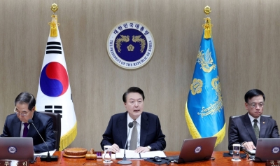 South Korean President Yoon Suk-yeol (center) speaks during a cabinet meeting at the presidential office in Seoul on Tuesday. South Korean hospitals turned away some patients and delayed surgeries on the day, as hundreds of trainee doctors stopped working in a protest against medical training reforms.