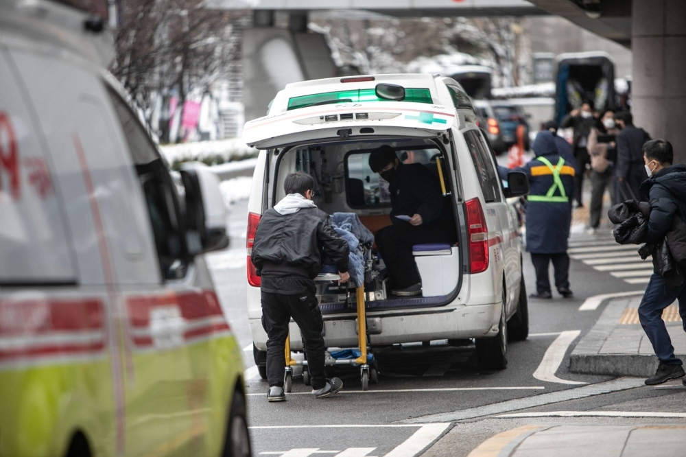 An emergency vehicle outside Severance Hospital in Seoul on Thursday. Almost two-thirds of the country's young doctors have walked off the job to protest a government plan to admit more students to medical schools.