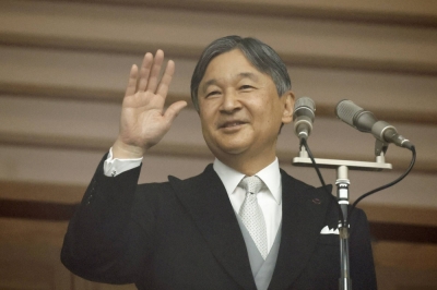 Emperor Naruhito waves to well-wishers from a balcony at the Imperial Palace in Tokyo on Friday, his 64th birthday.