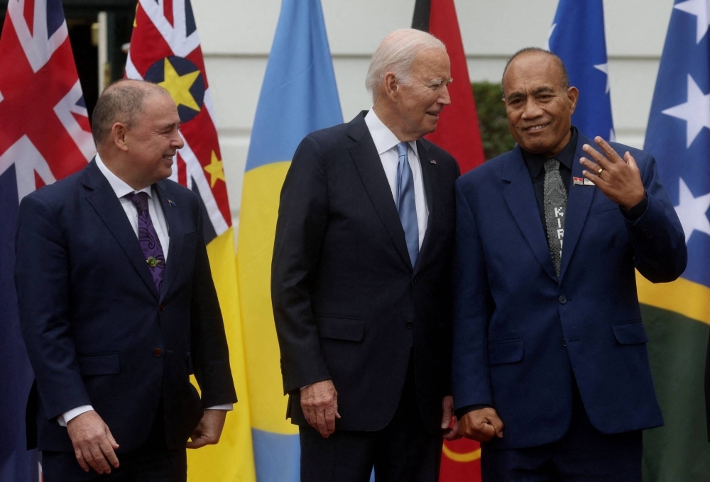 U.S. President Joe Biden chats with Kiribati President Taneti Maamau as Cook Islands Prime Minister Mark Brown looks on during a summit at the White House in Washington in September.