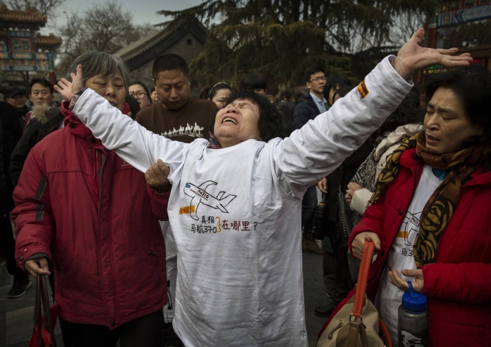 A relative of a missing passenger on MH370, in Beijing on the one year anniversary of the aircraft's disappearance. 