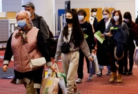 Ukrainian evacuees arrive at Tokyo's Haneda Airport in April 2022. | REUTERS