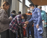 Prime Minister Fumio Kishida shakes hands with victims of the Noto Peninsula earthquake in the town of Anamizu, Ishikawa Prefecture, on Saturday. | KYODO