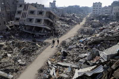 Palestinians walk past destroyed homes near the Jabalia refugee camp in the northern Gaza Strip on Thursday. 