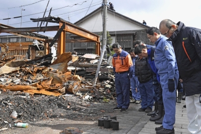 Prime Minister Fumio Kishida offers prayers at a site destroyed by fire in Wajima, Ishikawa Prefecture, on Saturday.