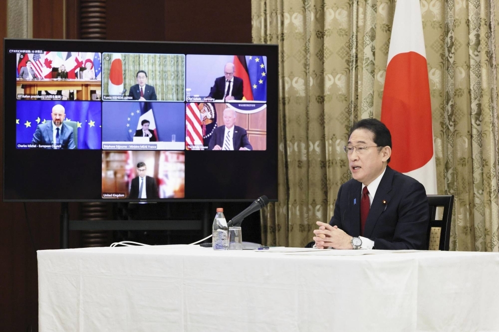 Prime Minister Fumio Kishida takes part in an online meeting of Group of Seven leaders at the Prime Minister's Office in Tokyo late Saturday, the second anniversary of Russia's invasion of Ukraine.