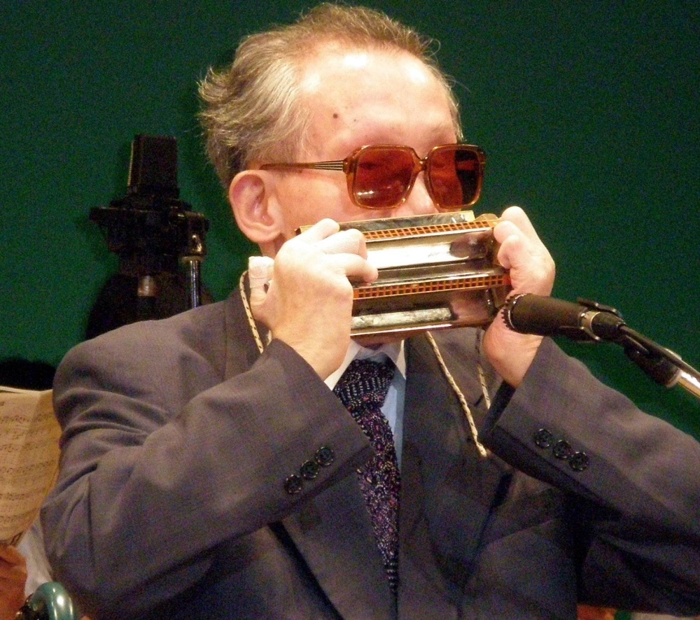 Koichi Kondo plays the harmonica. Playing harmonica was like life itself for members of the Bluebird Band, according to his words.