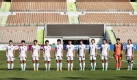 North Korea's national women's soccer team lines up during the national anthems before an Olympic qualifier against Japan on Saturday in Jeddah, Saudi Arabia. | REUTERS