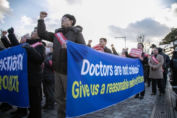 South Korean doctors and other demonstrators march during a protest in Seoul on Sunday.