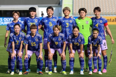 Japan's players pose for a group picture ahead of their soccer match against North Korea in Jeddah, Saudi Arabia, on Saturday.