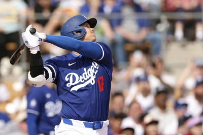 Dodgers designated hitter Shohei Ohtani hits a home run during the fifth inning of a preseason game against the White Sox on Tuesday.