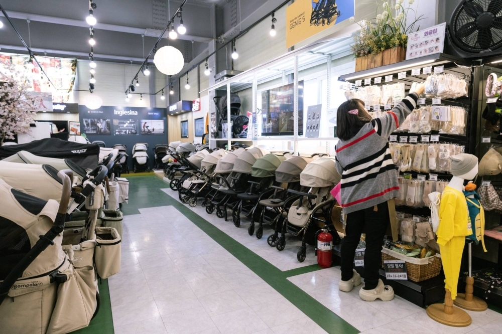An employee organizes baby supplies at a store in Siheung, South Korea, on Tuesday. A lack of babies is speeding up the aging of South Korean society, generating concerns about the growing fiscal burden of public pensions and healthcare.