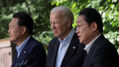 South Korean President Yoon Suk-yeol, U.S. President Joe Biden and Prime Minister Fumio Kishida hold a joint news conference during a trilateral summit at Camp David, Maryland, on Aug. 18. The summit dealt with security and economic security coordination.