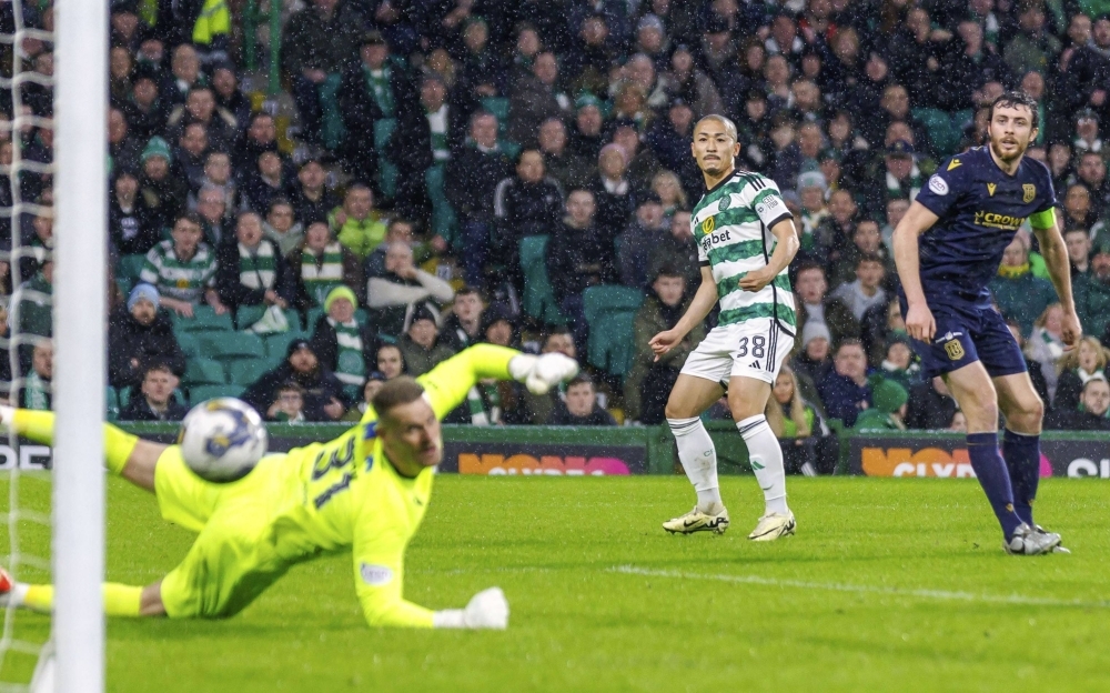 Celtic's Daizen Maeda scores against Dundee during their match in Glasgow, Scotland, on Wednesday.