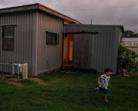 Aoi Suzuki’s son runs past a home in Taketomi on Iriomote Island (not to be confused with Taketomi Island, which lies to the east of Iriomote). The Suzukis run the Takemori Inn, one of the few hotels on Iriomote. | LANCE HENDERSTEIN