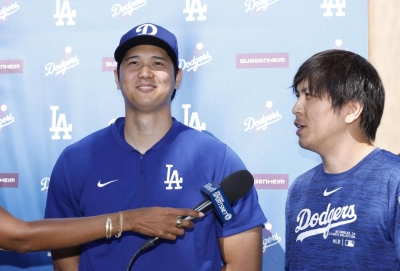 Dodgers star Shohei Ohtani and interpreter Ippei Mizuhara speak with the media at Camelback Ranch in Glendale, Arizona, on Thursday.