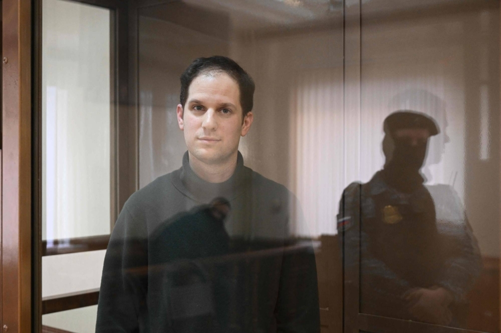 U.S. journalist Evan Gershkovich, arrested on espionage charges, stands inside a defendants' cage before a hearing to consider an appeal on his extended pre-trial detention, at the Moscow City Court in Moscow on Feb. 20.