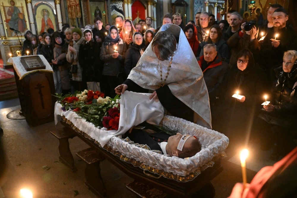 The body of late Russian opposition leader Alexei Navalny is seen during the funeral service at the Mother of God Quench My Sorrows Church in Moscow's Maryino district on Friday.