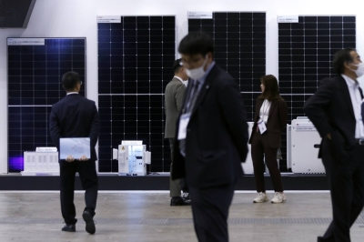 Solar panels on display at PV Expo in Tokyo on Wednesday. Japan's "transition bonds" will cover cutting-edge solar cells, as well as more controversial projects.