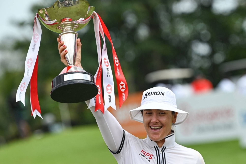 Hannah Green of Australia celebrates with the trophy after winning the final round of the HSBC Women's World Championship golf tournament in Singapore on Sunday. 