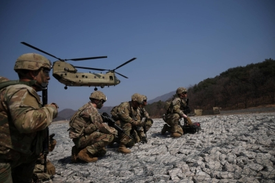 A U.S Army CH-47 Chinook helicopter lands as U.S. soldiers wait during the Freedom Shield joint military exercises between South Korea and the United States, at a training field near the Demilitarized Zone separating the two Koreas in Pocheon, South Korea, on March 19, 2023.