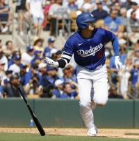 Shohei Ohtani of the Los Angeles Dodgers hits an RBI triple in the second inning of a spring training game against the Colorado Rockies in Glendale, Arizona, on Sunday. | Kyodo
