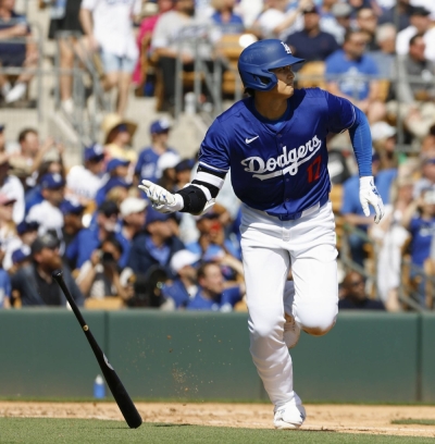 Shohei Ohtani of the Los Angeles Dodgers hits an RBI triple in the second inning of a spring training game against the Colorado Rockies in Glendale, Arizona, on Sunday.