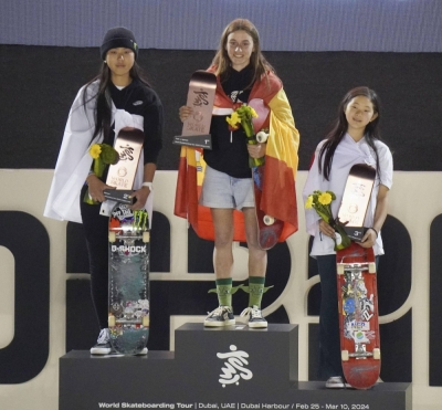 Second-place Kokona Hiraki (left) and third-place Mizuho Hasegawa (right) of Japan stand on the podium alongside Spain's Naia Laso, winner of the women's final at the Paris Olympic park skateboarding qualifier in Dubai on Sunday.