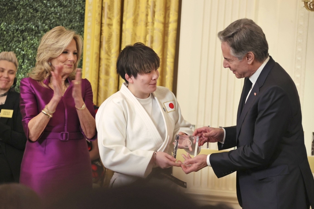Rina Gonoi (center) receives an award from U.S. Secretary of State Antony Blinken at a ceremony in Washington on Monday, with First Lady Jill Biden standing next to her. 