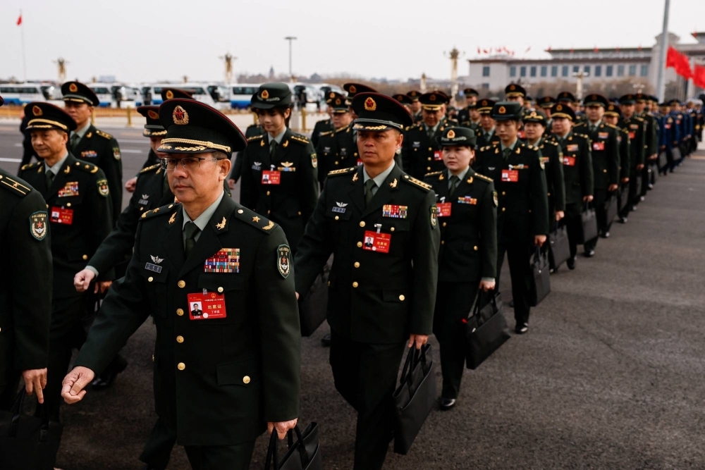 A military delegation arrives for a meeting Monday, ahead the annual session of China’s National People’s Congress (NPC) in Beijing.