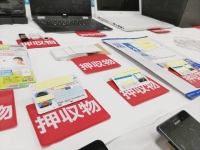 Documents, including forged driver's licenses, used in a fraud case are shown at Aichi Prefectural Police's Kasugai police station on Monday. | Jiji