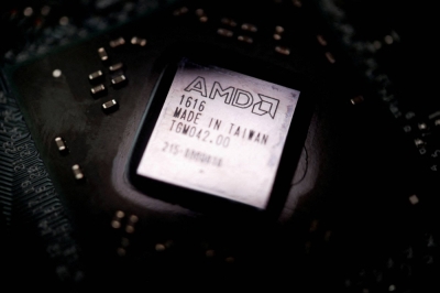 The logo of semiconductor company Advanced Micro Devices is seen on a graphics processing unit chip in this illustration