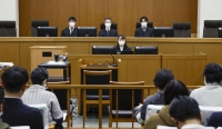 Judges at the Kyoto District Court hear a case involving Yoshikazu Okubo, a doctor accused of the consensual killing of a woman with a fatal neurological disease, on Jan. 11. | Kyodo


