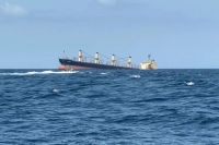 The Rubymar cargo ship sinking off the coast of Yemen on Feb. 27. The vessel had 21,000 metric tons of ammonium phosphate sulfate fertilizer on board. | AFP-Jiji