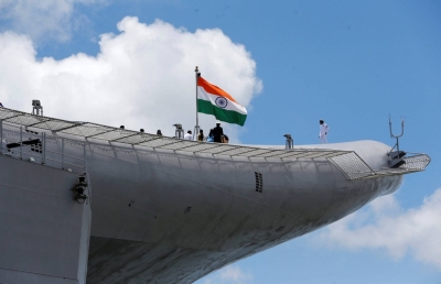 Indian Navy officers stand on the flight deck of India's first home-built aircraft carrier INS Vikrant in Kochi, India, in September 2022.