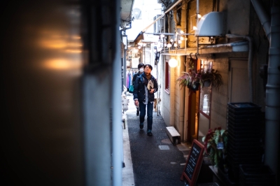 Hideo Takayama (front) and Nama Yoshimura head down a narrow alley where a small stream used to run.