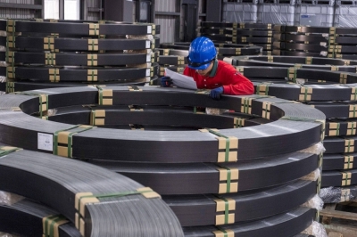 A worker checks the carbon fiber at the composite production line at the Swancor factory in Nantou, Taiwan, in February.