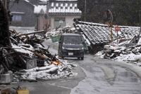 Homes destroyed in the New Year's Day earthquake line a road in Suzu, Ishikawa Prefecture, on March 3. | KYODO