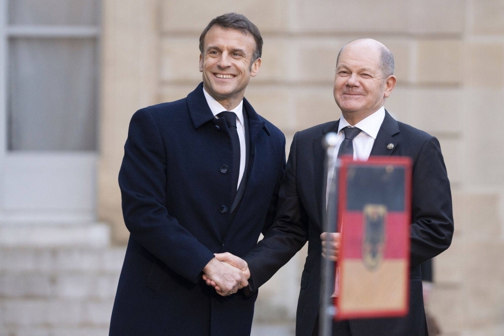 French President Emmanuel Macron greets Germany Chancellor Olaf Scholz at the Elysee Palace in Paris on Feb. 26.