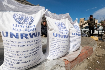 Displaced Palestinians wait to receive United Nations Relief and Works Agency (UNRWA) aid, amid the ongoing conflict between Israel and the Palestinian Islamist group Hamas, in Rafah, in the southern Gaza Strip, on Thursday.