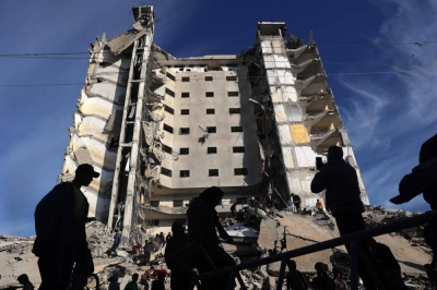 Palestinians gather in front of a residential building hit in an overnight Israeli air strike in Rafah in the southern Gaza Strip on Saturday. 