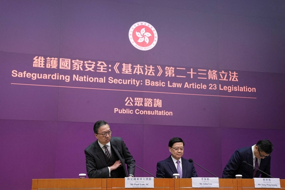 From left: Hong Kong's Secretary for Justice Paul Lam, Chief Executive John Lee and Secretary for Security Chris Tang Ping-keung hold a news conference regarding national security laws, in Hong Kong on Jan. 30. 
