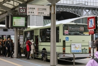 People line up to board a city bus outside JR Kyoto Station in Kyoto on Feb. 29. | Kyodo