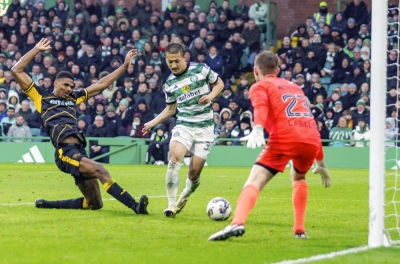 Celtic's Daizen Maeda scores his third goal against Livingston during the Scottish Cup quarterfinals in Glasgow, Scotland, on Sunday. Celtic won 4-2.