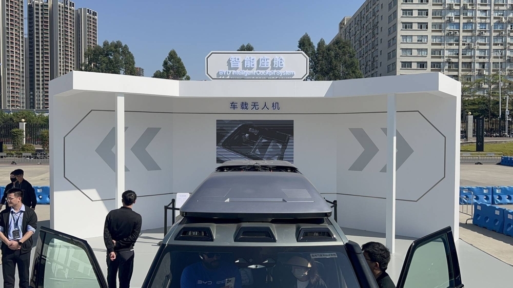 A DJI drone emerges from the casing on top of a BYD Yangwang U8 vehicle.