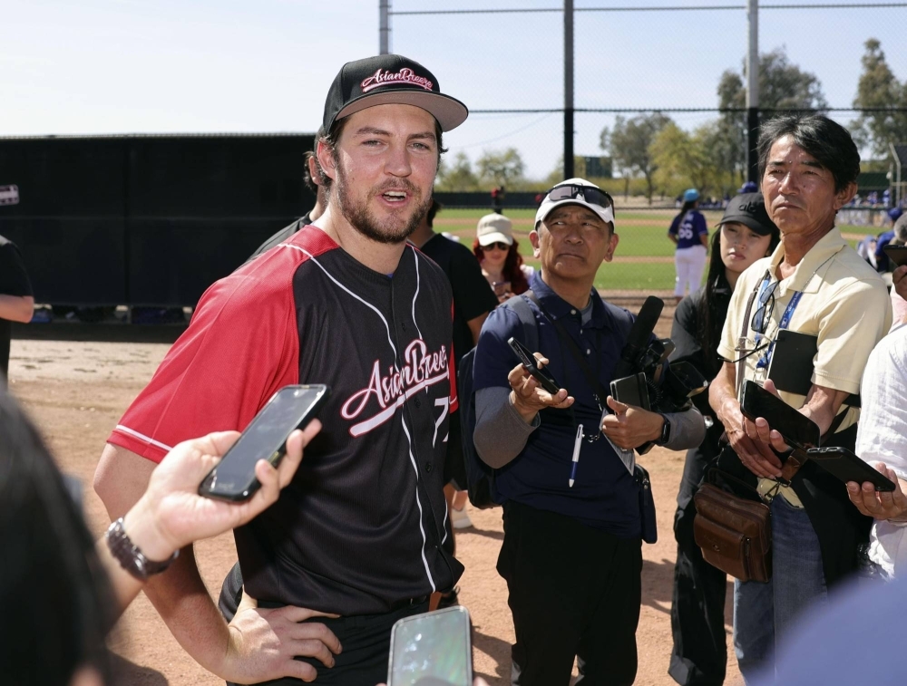 Trevor Bauer speaks to reporters after pitching for the Asian Breeze in an exhibition in Glendale, Arizona, on Sunday.