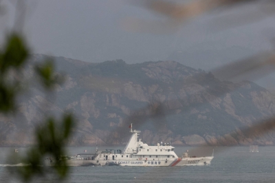 A China Coast Guard ship sails during a military drill near Fuzhou, in China's Fujian Province, near the Taiwan-controlled Matsu Islands that are close to the Chinese coast.
