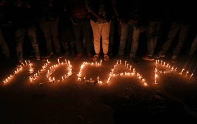Protesters spell out "No CAA" using candles during a protest against the Citizenship Amendment Act in New Delhi on Dec. 29, 2019. The law grants Indian nationality to people who fled to India due to religious persecution from neighboring Muslim-majority countries before Dec. 31, 2014.